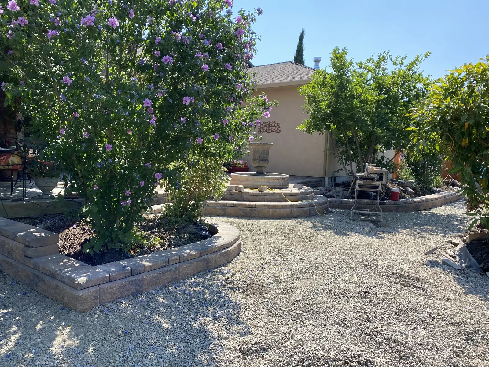 Paver courtyard with a garden fountain